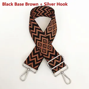 Detail of adjustable nylon strap with brown geometric pattern and silver metal hooks