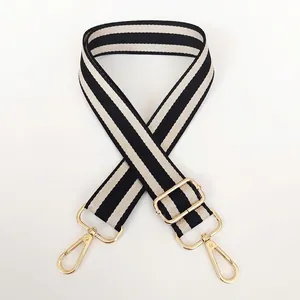 Adjustable black and beige striped crossbody bag strap with gold metal swivel hooks