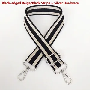 Detail of adjustable black and white striped canvas strap with silver metal hooks
