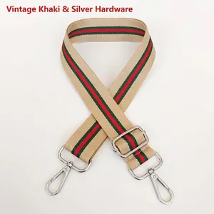 Detail of adjustable vintage khaki canvas strap with classic red and green stripes and silver hooks