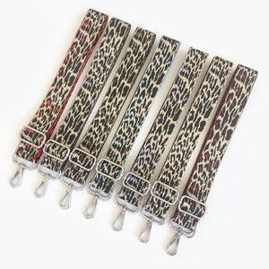 Detailed view of colorful leopard print shoulder straps with adjustable silver metal hooks