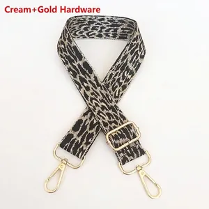 Detail of adjustable leopard print bag strap in creamy white with gold metal hooks