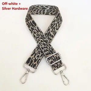 Detail of off-white leopard pattern shoulder strap with silver metal hooks and buckle