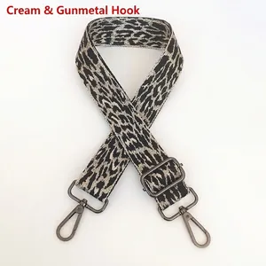 Detail view of off-white leopard print bag strap with gunmetal hooks and adjustment buckle