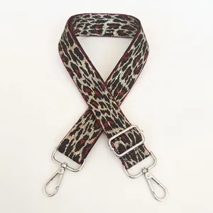 Close-up of wine red leopard print handbag strap with adjustable silver metal hooks
