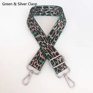 Detail of adjustable leopard print bag strap in green and beige with silver hooks