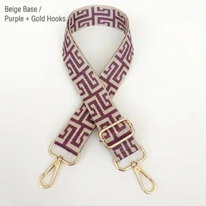 Detail of adjustable beige and purple geometric jacquard bag strap with gold lobster clasps