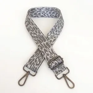Detail of adjustable leopard print bag strap in grey and white with gunmetal swivel hooks