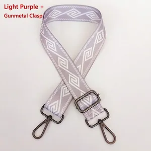 Detail view of light purple geometric nylon bag strap with gunmetal swivel hooks