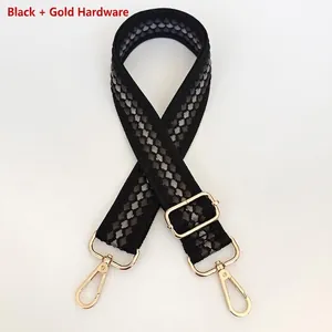 Detailed view of adjustable black and grey woven strap with polished gold metal hardware