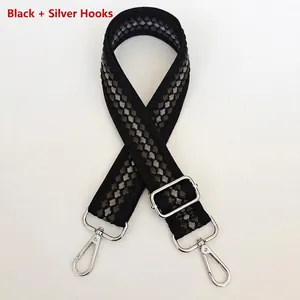Close-up of durable woven check pattern bag strap with polished silver metal lobster clasps
