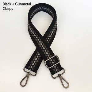 Detail of widened woven bag strap with black grey rhombus pattern and gunmetal hook