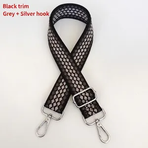 Detail of grey diamond patterned woven bag strap with durable silver metal lobster hooks