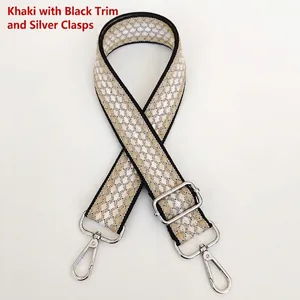 Close-up of khaki geometric jacquard woven bag strap with silver metal hooks