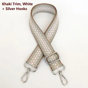 Detail of adjustable plaid shoulder strap with silver hooks and khaki geometric patterns