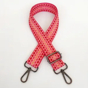 Close-up of pink geometric plaid bag strap with durable gunmetal swivel snap hooks