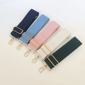 Detail view of five multi-color adjustable cotton canvas shoulder straps with gold hooks