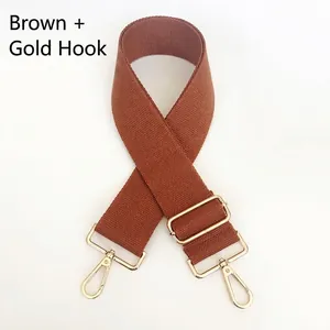 Adjustable brown canvas strap for shoulder bags with gold metal hooks and buckle
