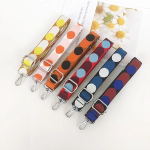Detailed view of adjustable polka dot replacement straps with silver metal snap hooks