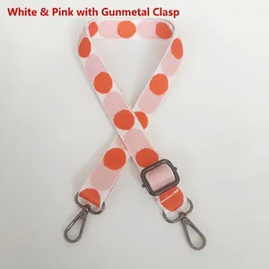 Close-up of white and pink polka dot adjustable strap with durable gunmetal hook