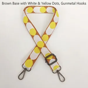 Close-up of brown adjustable polka dot bag strap with gunmetal swivel snap hooks