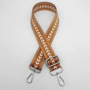 Adjustable brown nylon shoulder strap with white herringbone pattern and silver metal hooks