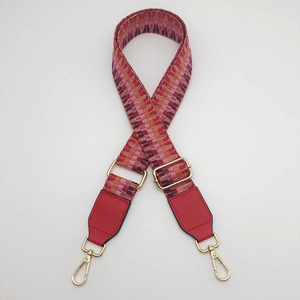 Adjustable woven shoulder strap for handbags with geometric V-pattern and gold hardware