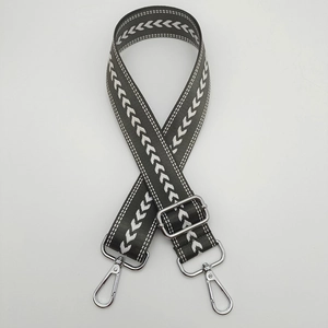 Detail of adjustable nylon strap with white arrow patterns and silver metal buckles