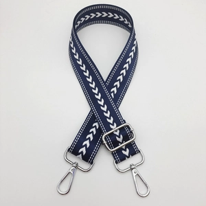 Detail showing navy nylon strap with white arrow pattern and silver metal swivel lobster hooks