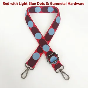 Detailed view of red and light blue wave patterns on woven adjustable canvas bag strap