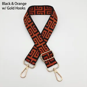 Adjustable canvas shoulder strap with orange and black Greek key geometric pattern and gold hooks