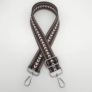 Adjustable brown nylon bag strap with white arrow pattern and silver metal swivel hooks