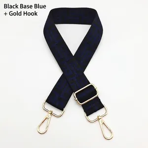 Detail of adjustable canvas strap with geometric pattern and golden metal hook fasteners