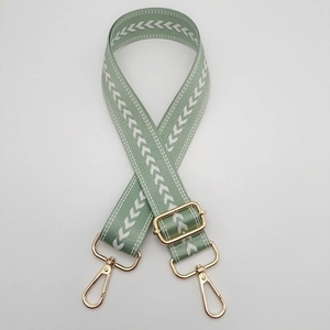 Adjustable light green nylon strap with white arrow pattern and gold metal buckles
