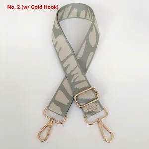 Adjustable wide canvas bag strap with grey abstract pattern and gold metal hooks