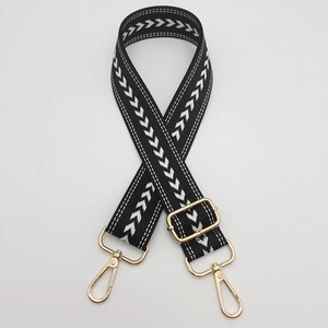 Adjustable nylon shoulder strap with black and white arrow pattern and gold metal hooks