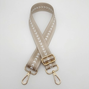 Adjustable wide nylon bag strap with white arrow pattern and gold metal hardware