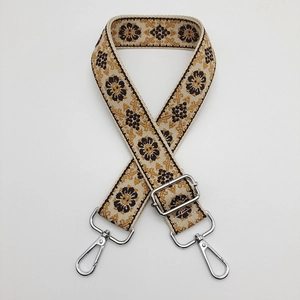 Detail of vintage floral embroidered bag strap with polished silver metal swivel hook