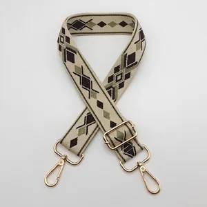 Close-up of geometric patterned replacement bag strap with golden metal swivel hooks