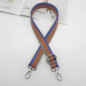 Detail of adjustable purple and orange diagonal stripe woven strap with silver metal buckles