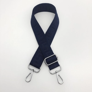 Detail of navy blue wide canvas strap with meander pattern and silver metal hooks
