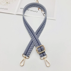 Detailed view of navy and white striped canvas strap with gold adjustable metal buckles