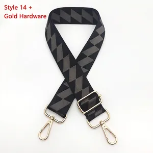 Detail of adjustable woven bag strap with grey geometric pattern and gold swivel hooks