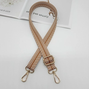Detail of wave pattern woven shoulder strap with gold metal swivel lobster hooks