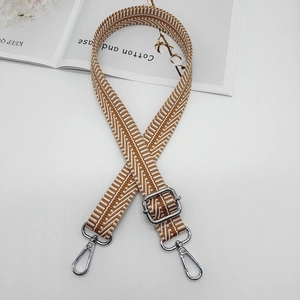 Adjustable woven canvas shoulder strap with orange and white herringbone geometric pattern