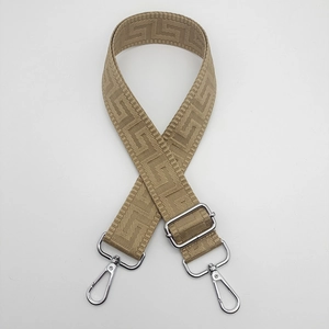 Close-up of adjustable meander pattern canvas bag strap with silver metal swivel hooks