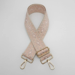 Close-up of diamond pattern nylon bag strap with golden metal swivel hooks and buckles