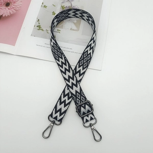 Detail of adjustable black and white chevron canvas strap with gunmetal swivel hooks
