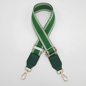 Detail of adjustable green and white chevron woven strap with gold metal hooks