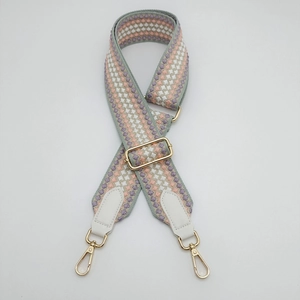 Detail of adjustable 5cm wide shoulder strap with macaron geometric embroidery and gold buckle